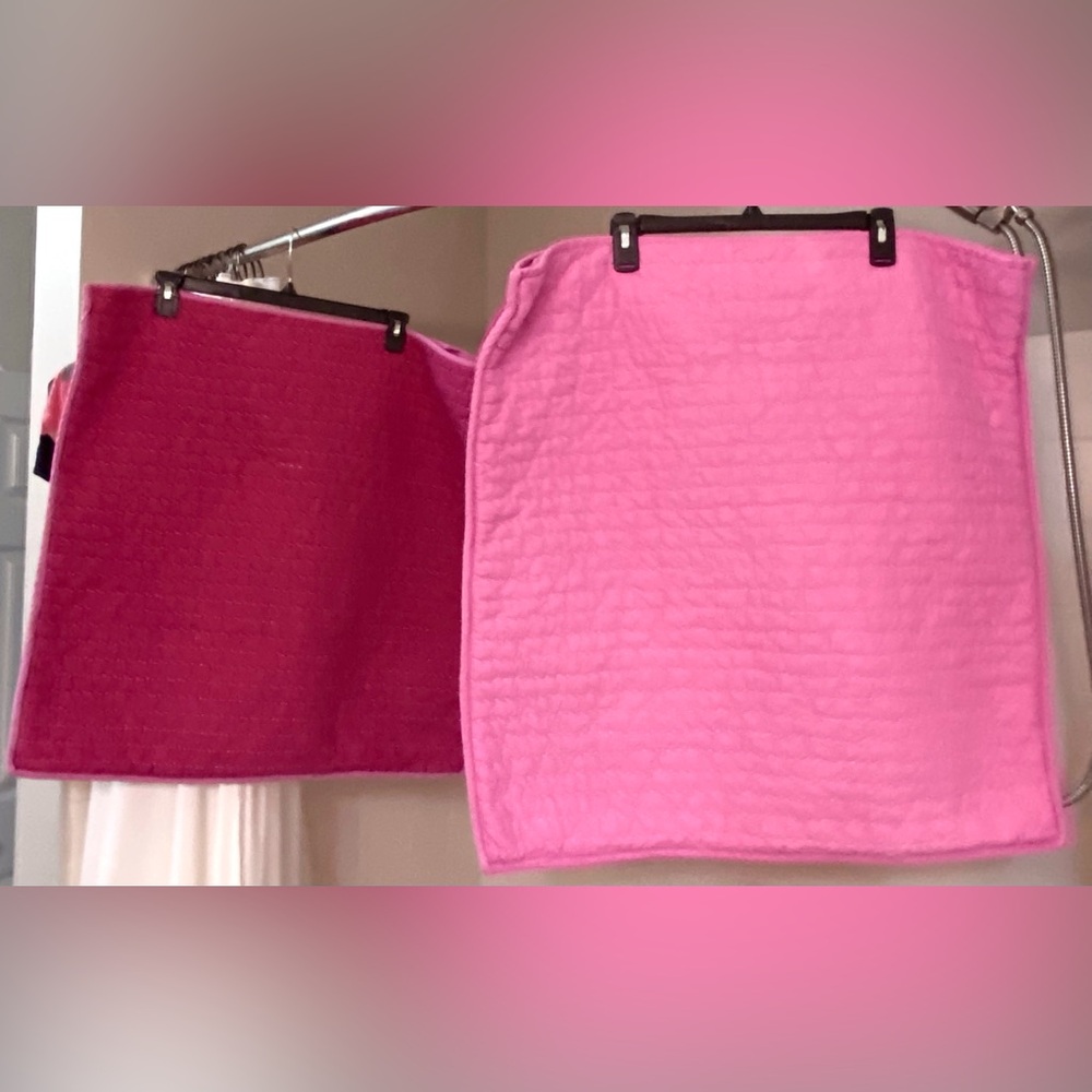 Two large pillow covers.  They are 26 in square. One side pink,other side darker
